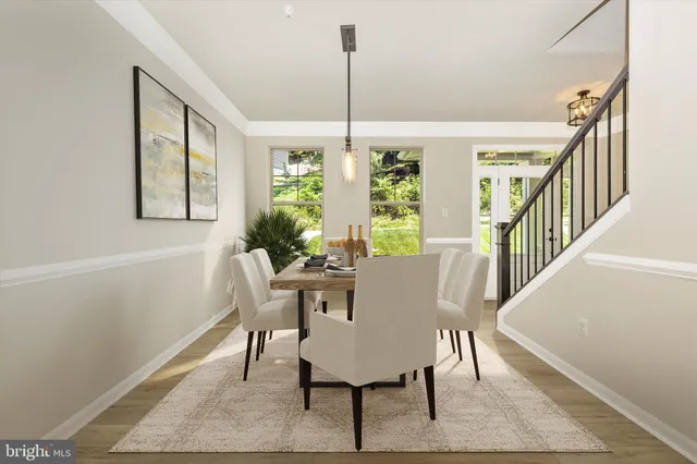 a kitchen with a sink a wooden floor and a large window