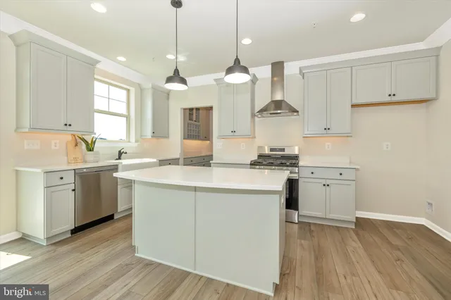 a living room with furniture fireplace and a large window