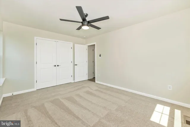 a view of a bench in the garden near a lake