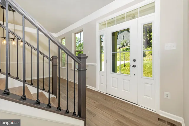 a view of wooden floor and windows in a room