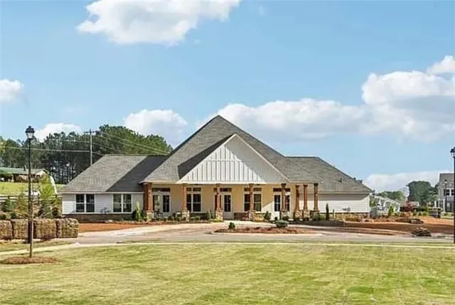 a front view of a house with swimming pool and porch