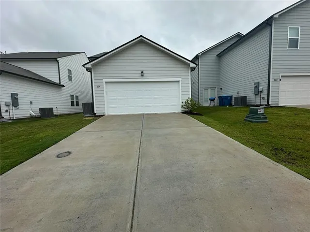 a front view of house with yard and green space
