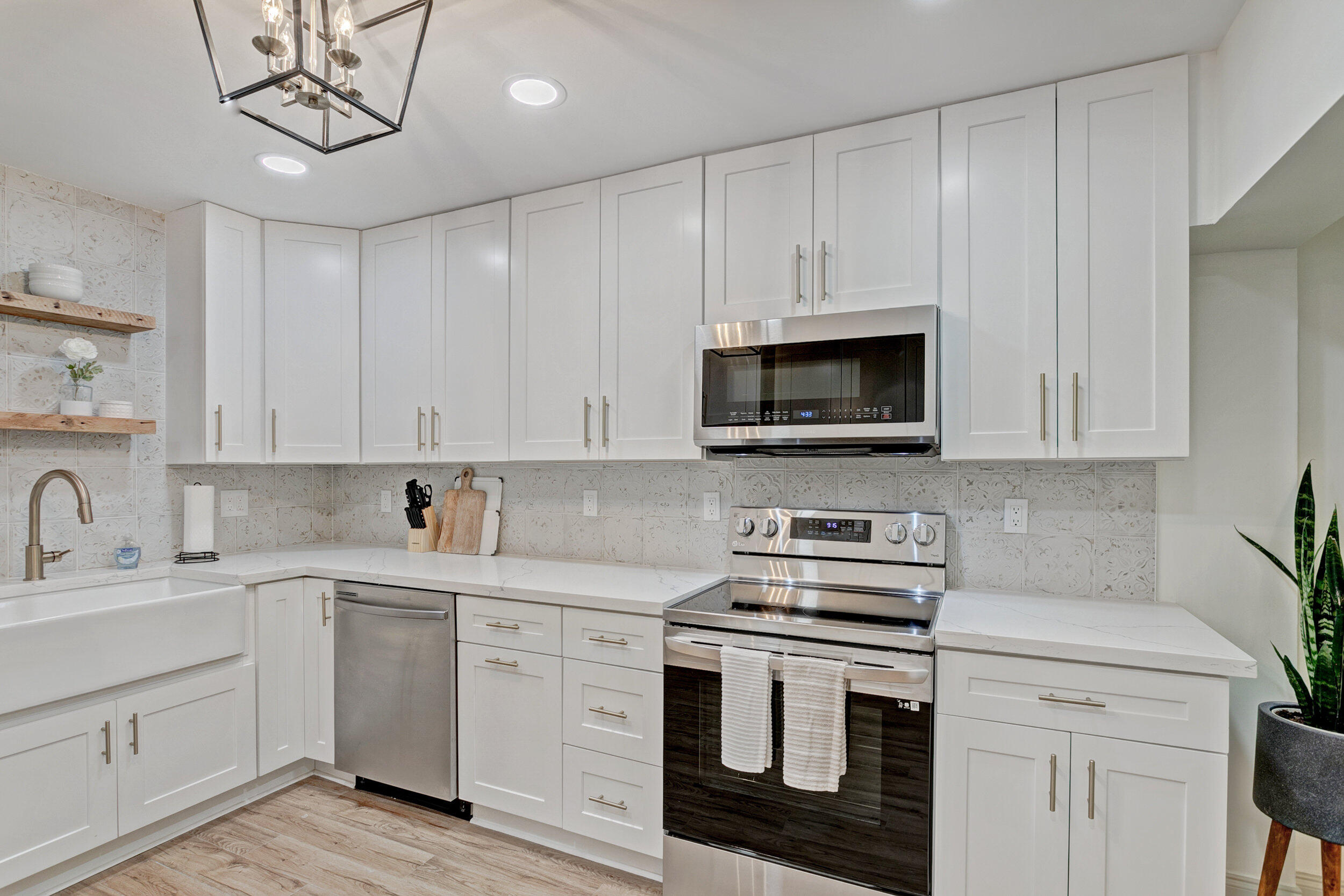 24 Ironwood Way North Palm Beach Gardens, FL 33418 - Photo 17 of 74 a kitchen with white cabinets and white appliances