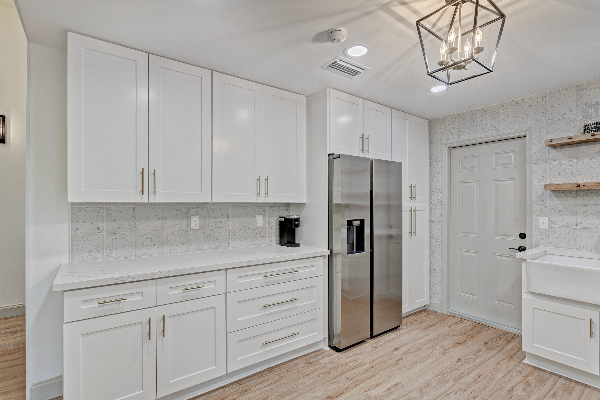 24 Ironwood Way North Palm Beach Gardens, FL 33418 - Photo 18 of 74 a kitchen with a refrigerator and cabinets