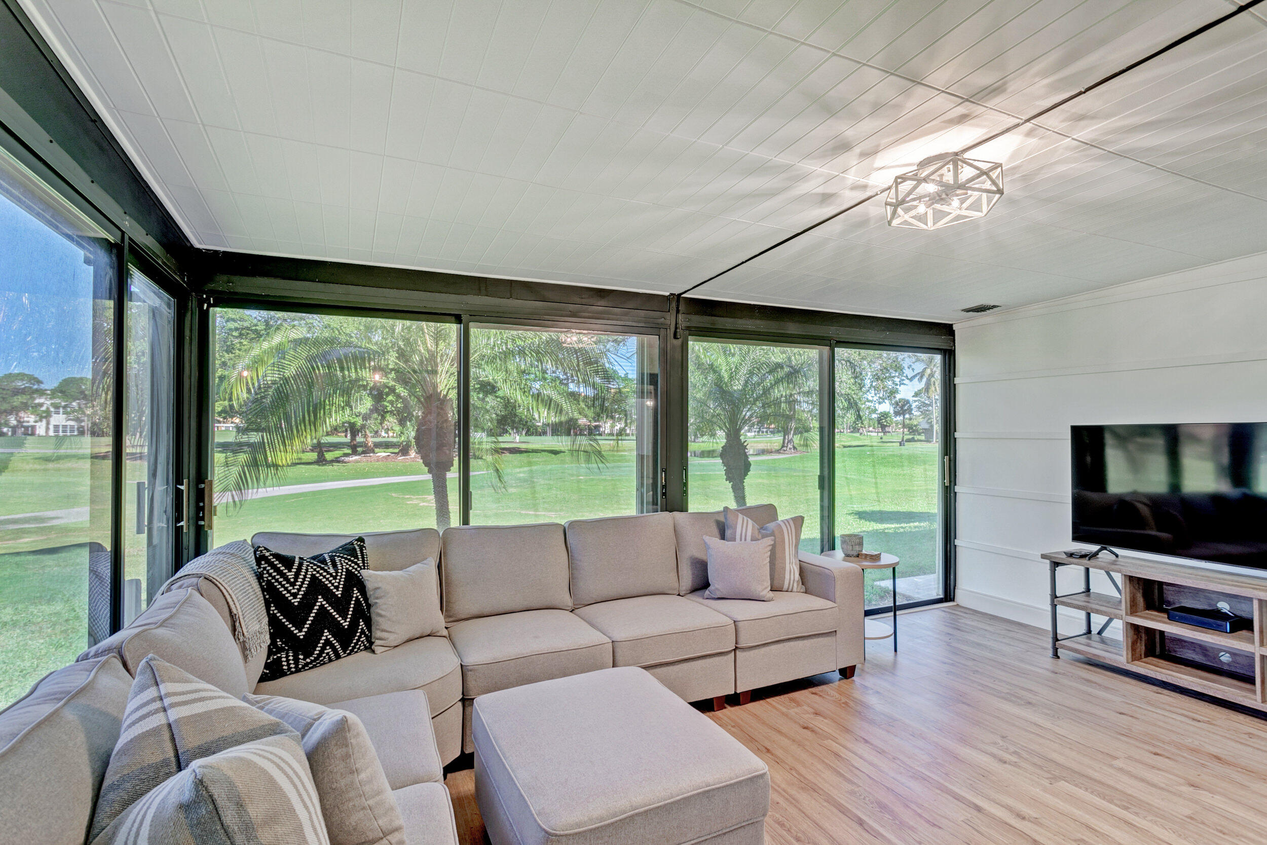24 Ironwood Way North Palm Beach Gardens, FL 33418 - Photo 25 of 74 a living room with furniture a flat screen tv and a large window
