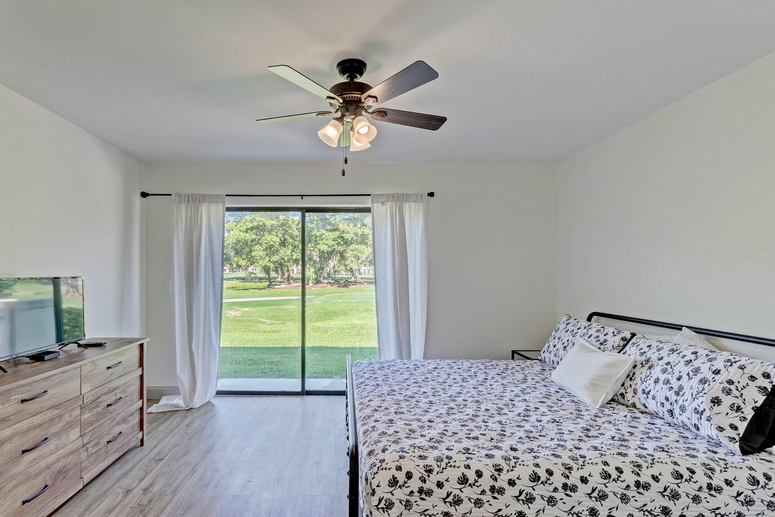 24 Ironwood Way North Palm Beach Gardens, FL 33418 - Photo 28 of 74 a bedroom with a bed and a flat screen tv