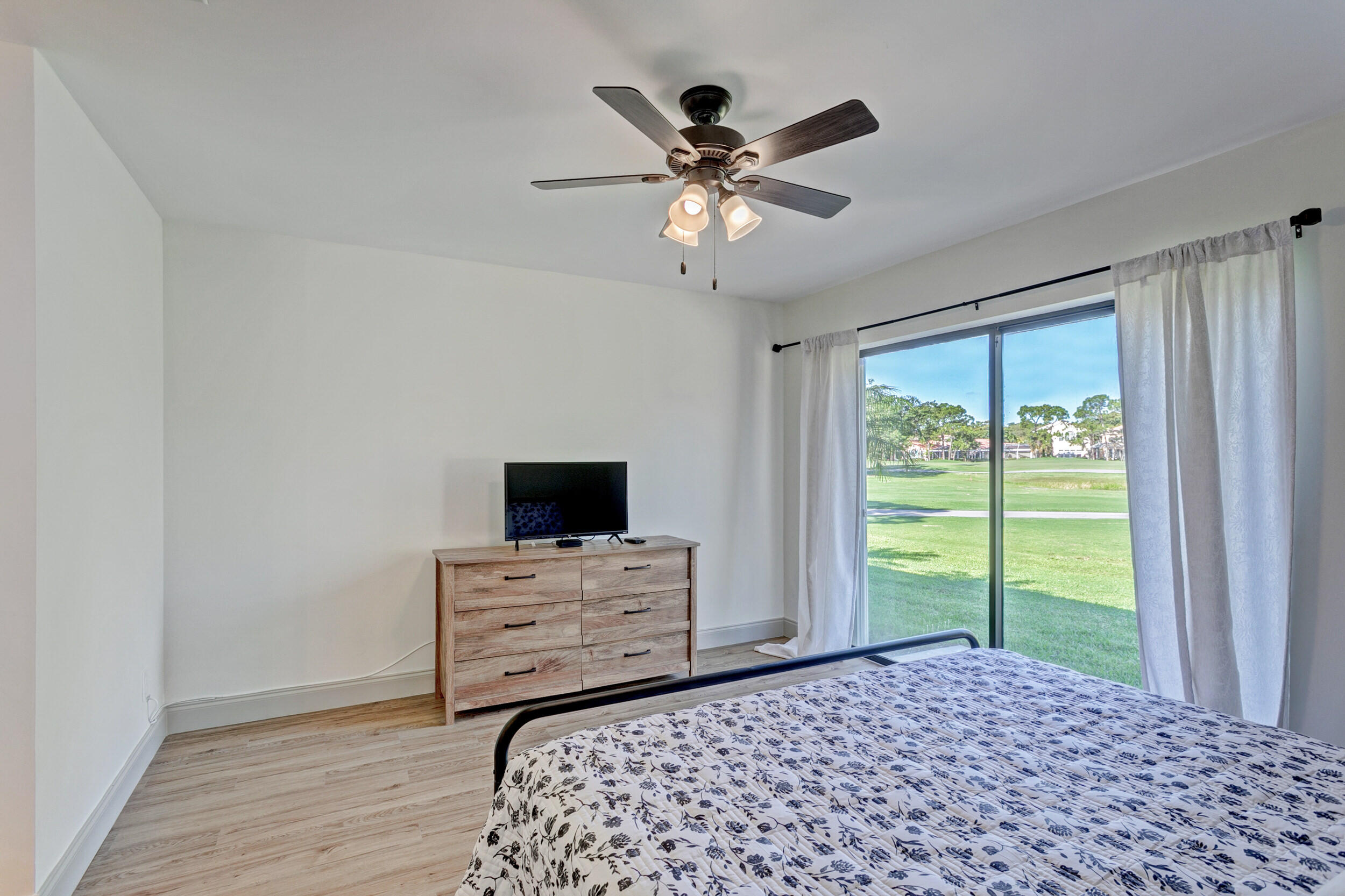 24 Ironwood Way North Palm Beach Gardens, FL 33418 - Photo 29 of 74 a living room with a flat screen tv and a window