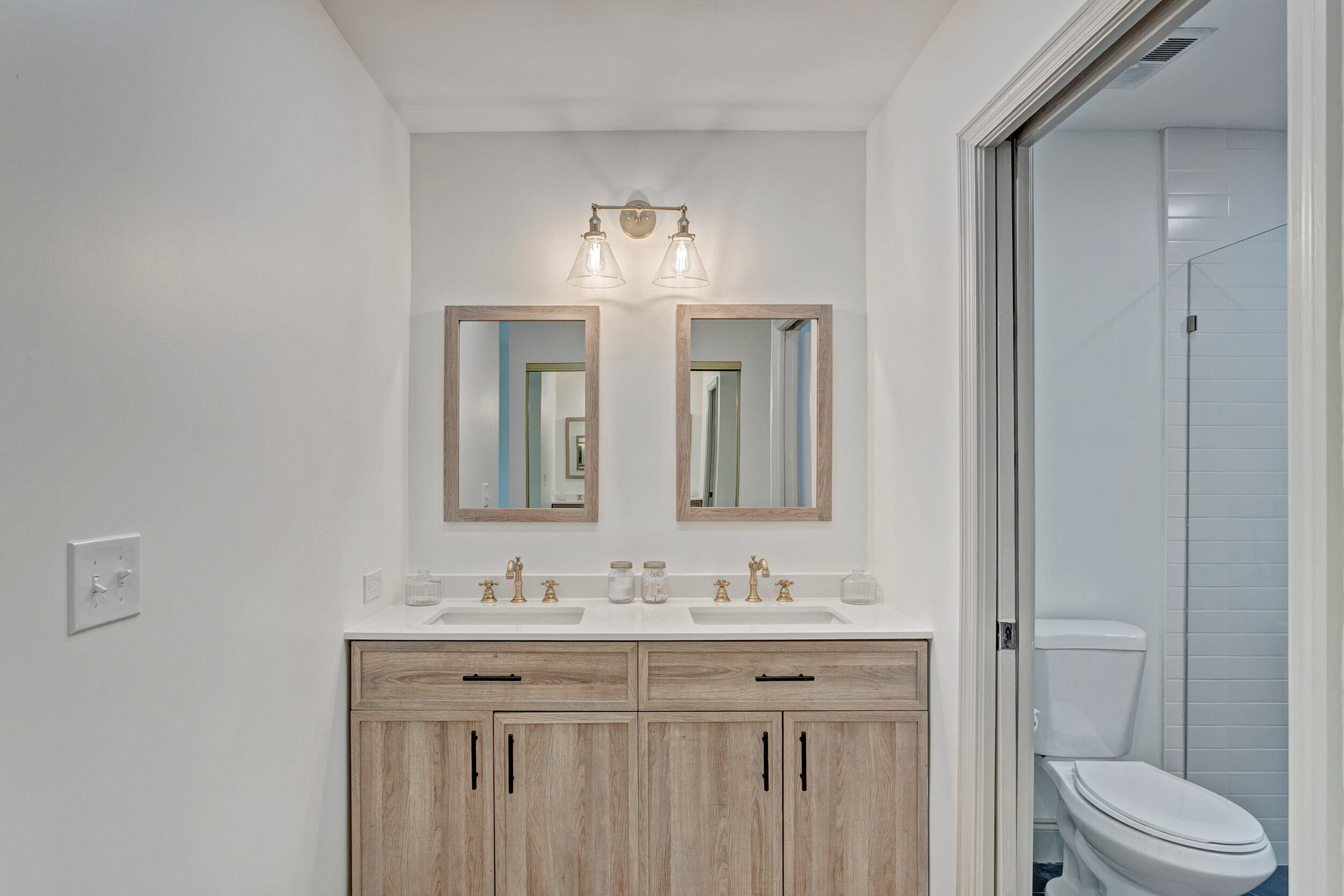 24 Ironwood Way North Palm Beach Gardens, FL 33418 - Photo 31 of 74 a bathroom with a granite countertop sink a toilet and a mirror