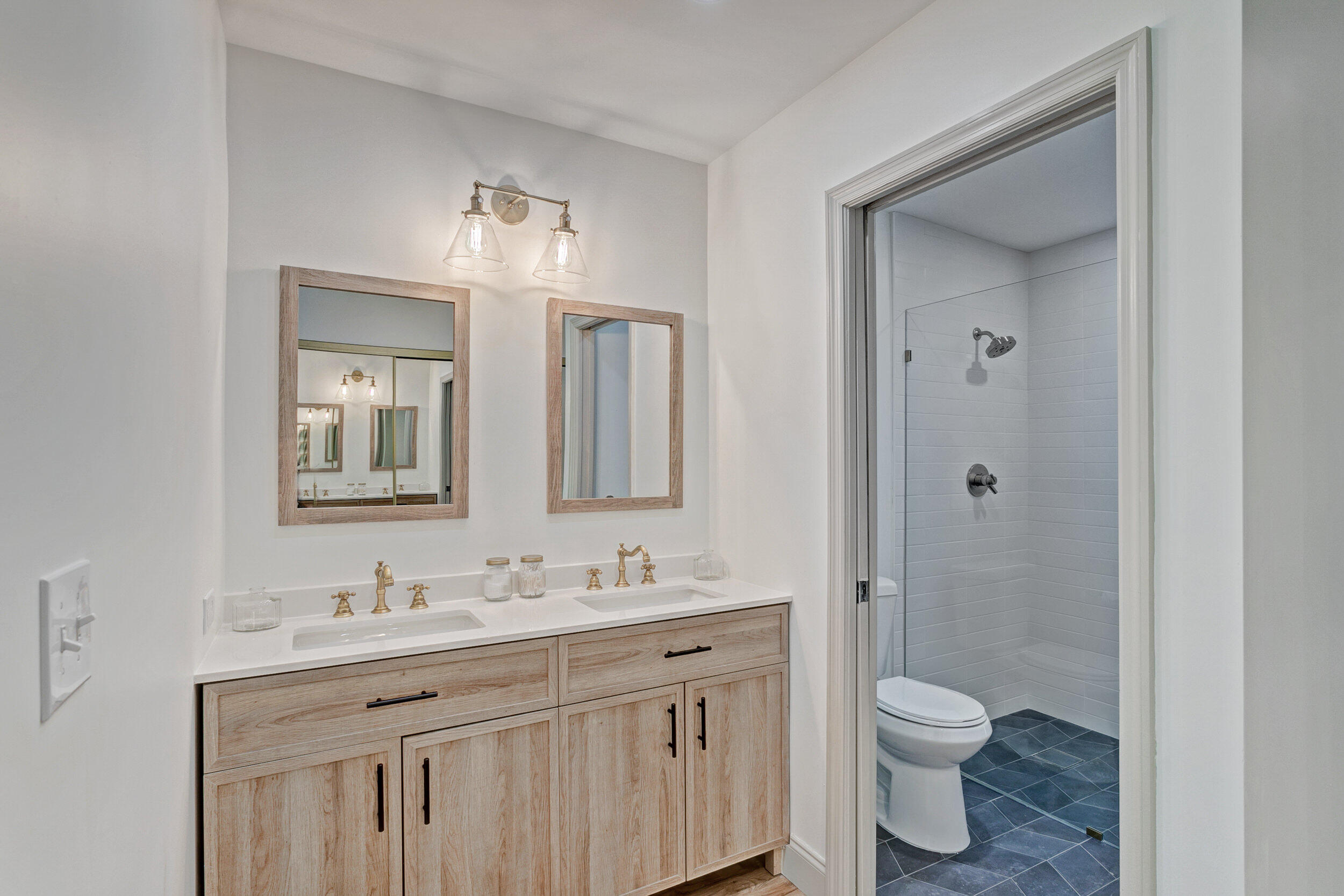 24 Ironwood Way North Palm Beach Gardens, FL 33418 - Photo 32 of 74 a bathroom with a granite countertop sink toilet a mirror and shower
