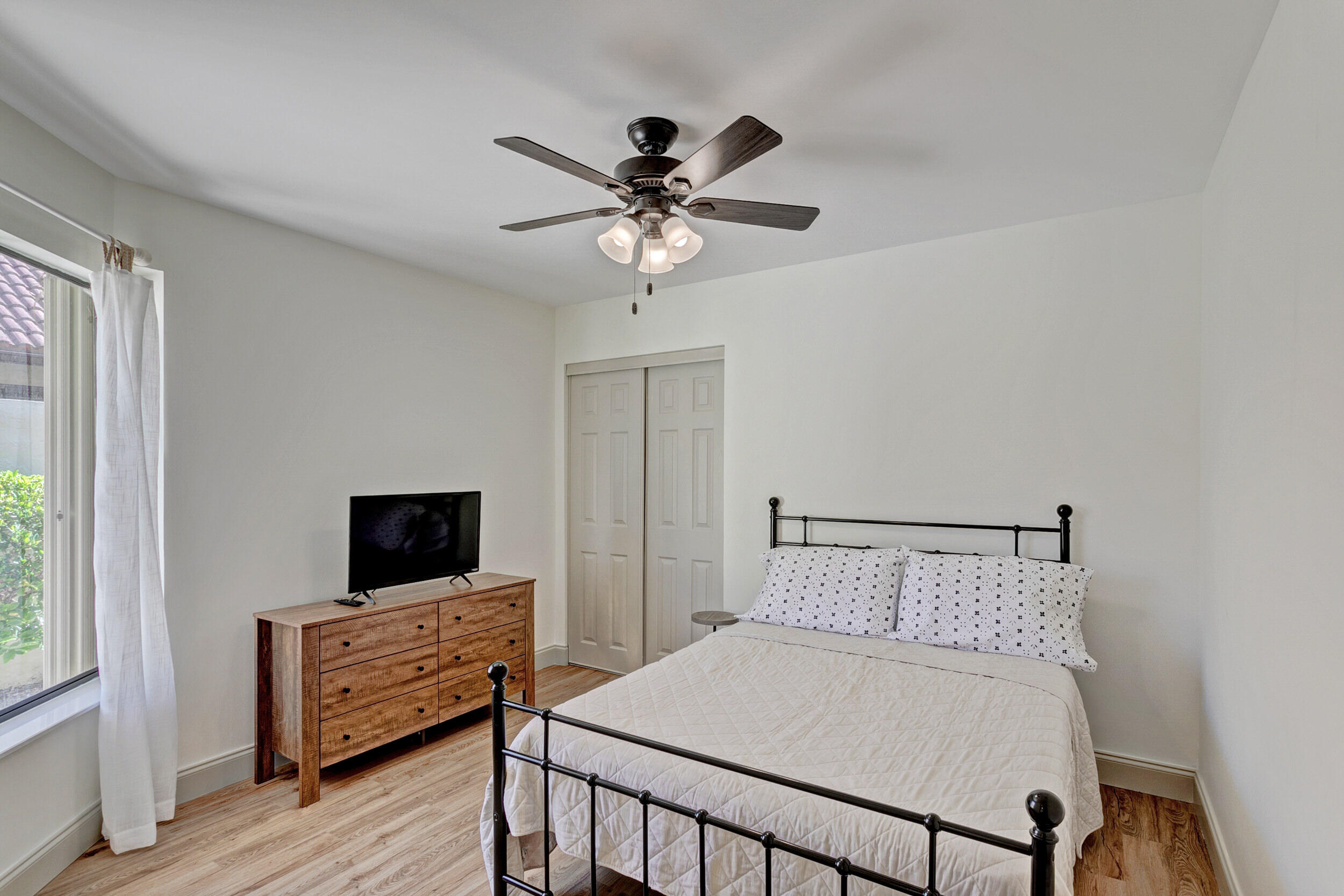 24 Ironwood Way North Palm Beach Gardens, FL 33418 - Photo 34 of 74 a bedroom with a bed and a flat screen tv