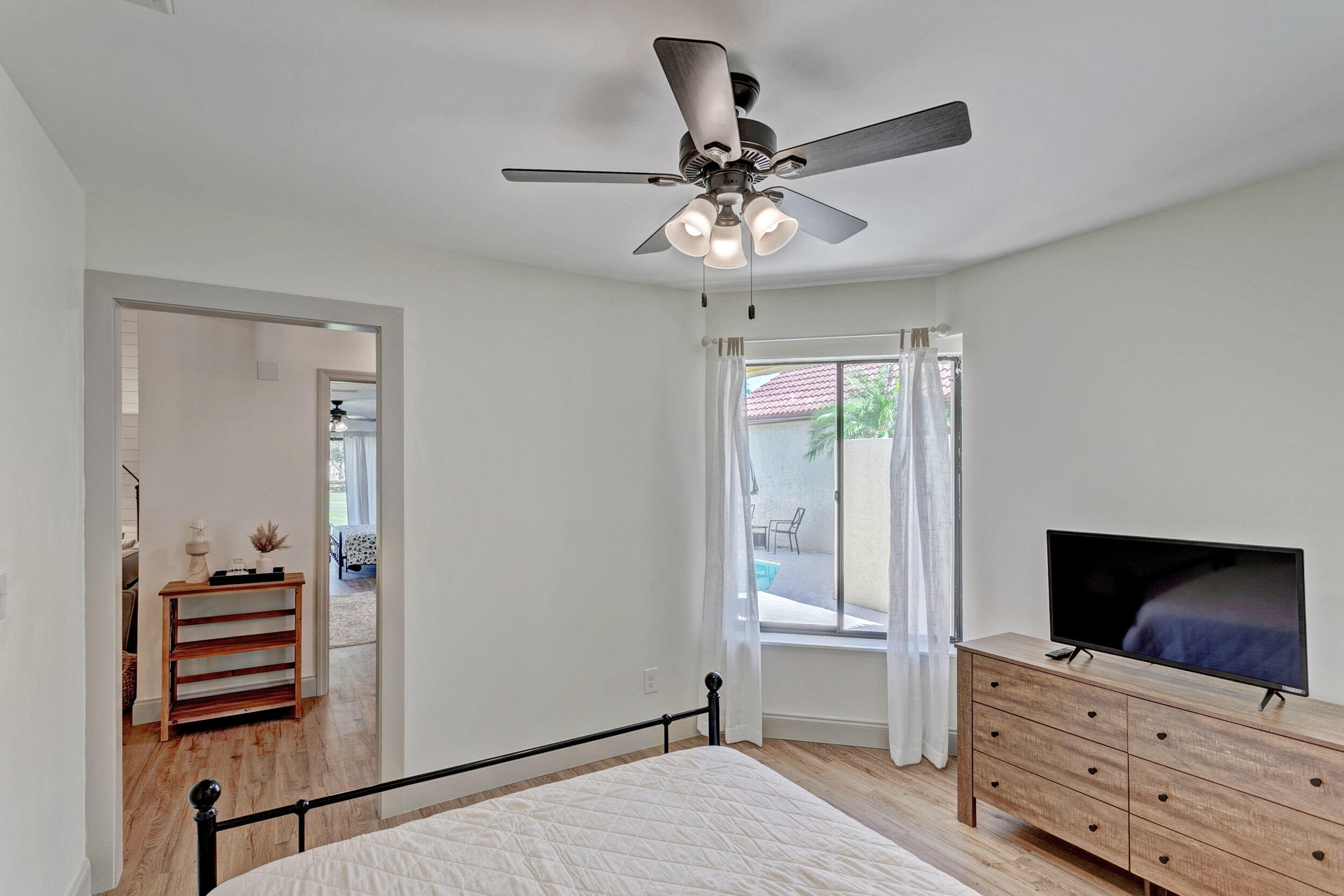 24 Ironwood Way North Palm Beach Gardens, FL 33418 - Photo 35 of 74 a view of a livingroom with wooden floor cabinet and a flat screen tv
