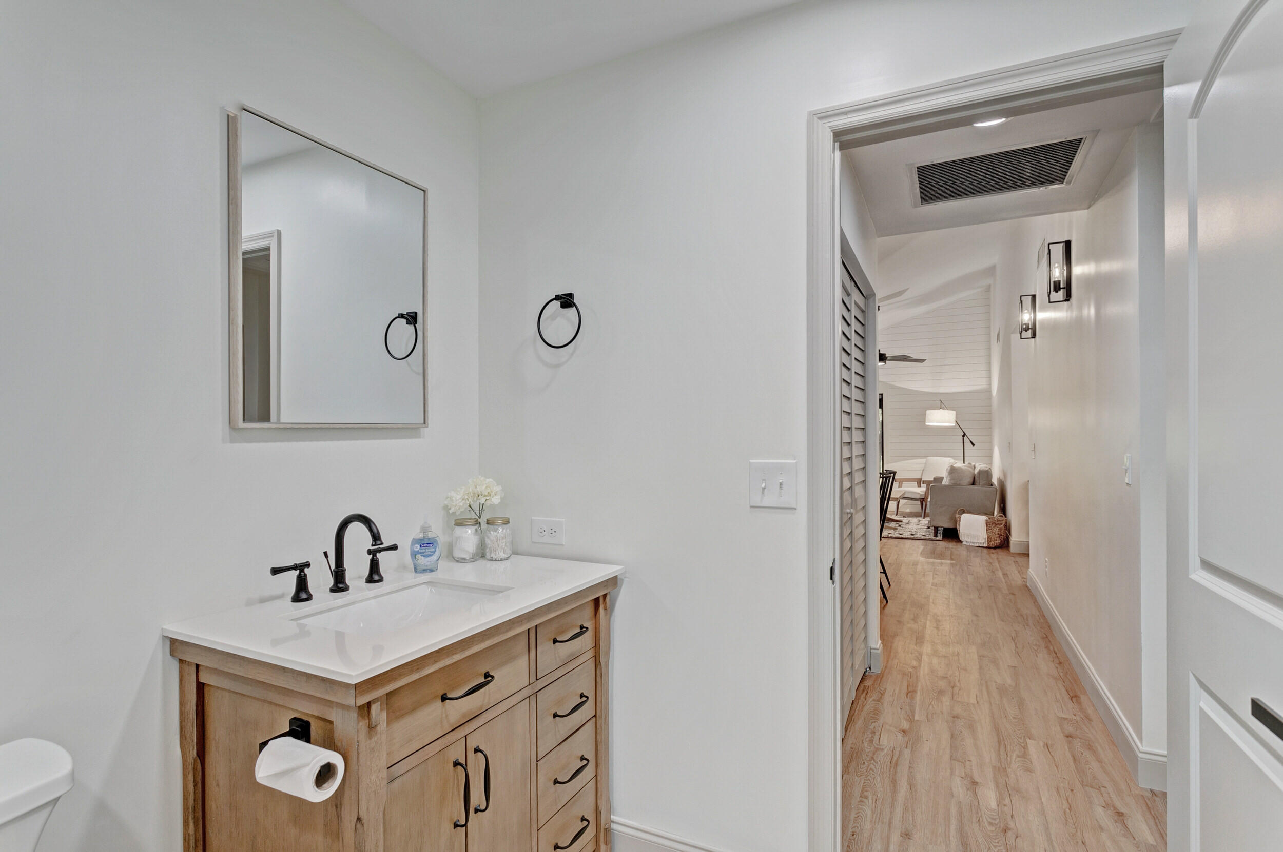 24 Ironwood Way North Palm Beach Gardens, FL 33418 - Photo 39 of 74 a en suite bathroom with a sink a mirror and a toilet