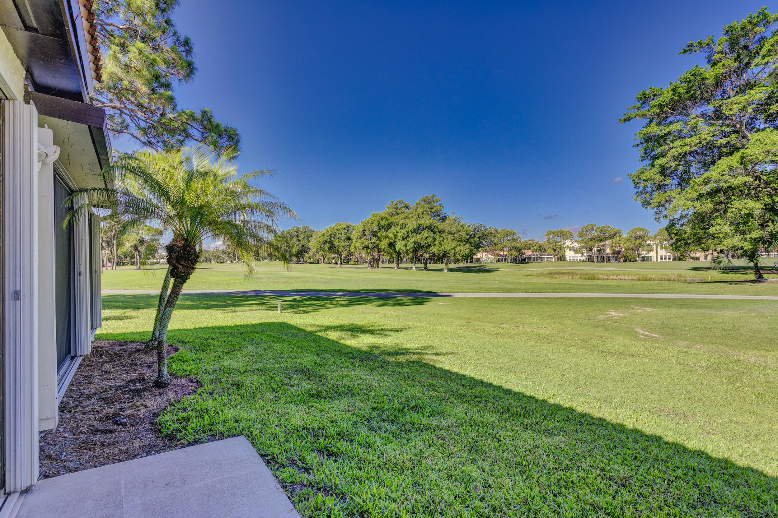 24 Ironwood Way North Palm Beach Gardens, FL 33418 - Photo 61 of 74 a view of a garden with a lake