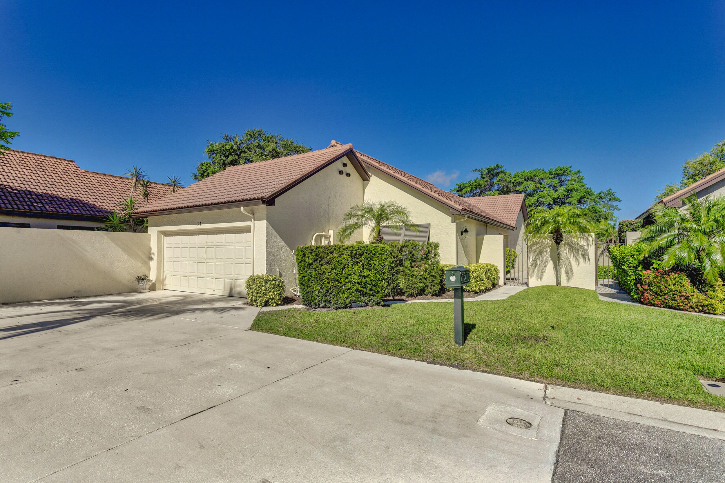 24 Ironwood Way North Palm Beach Gardens, FL 33418 - Photo 64 of 74 a front view of a house with a yard and garage