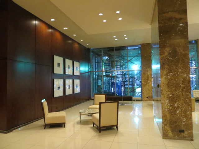 655 West Irving Park Road, Unit 2710 Chicago, IL 60613 - Photo 2 of 11 a lobby with furniture and a potted plant
