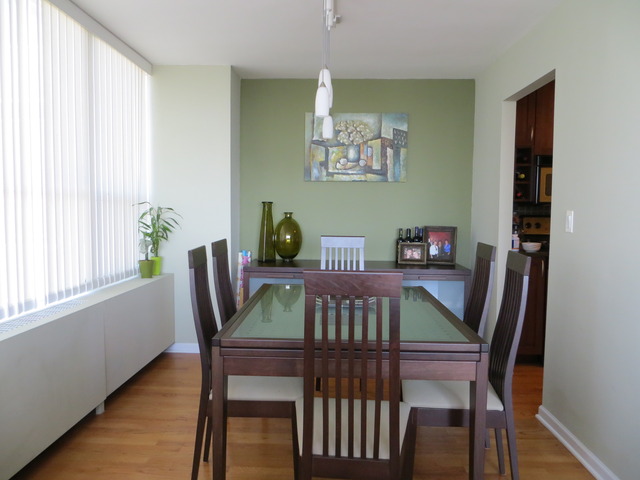 655 West Irving Park Road, Unit 2710 Chicago, IL 60613 - Photo 4 of 11 a view of a dining room with furniture window and wooden floor