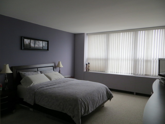 655 West Irving Park Road, Unit 2710 Chicago, IL 60613 - Photo 6 of 11 a bed sitting in a bedroom next to a window