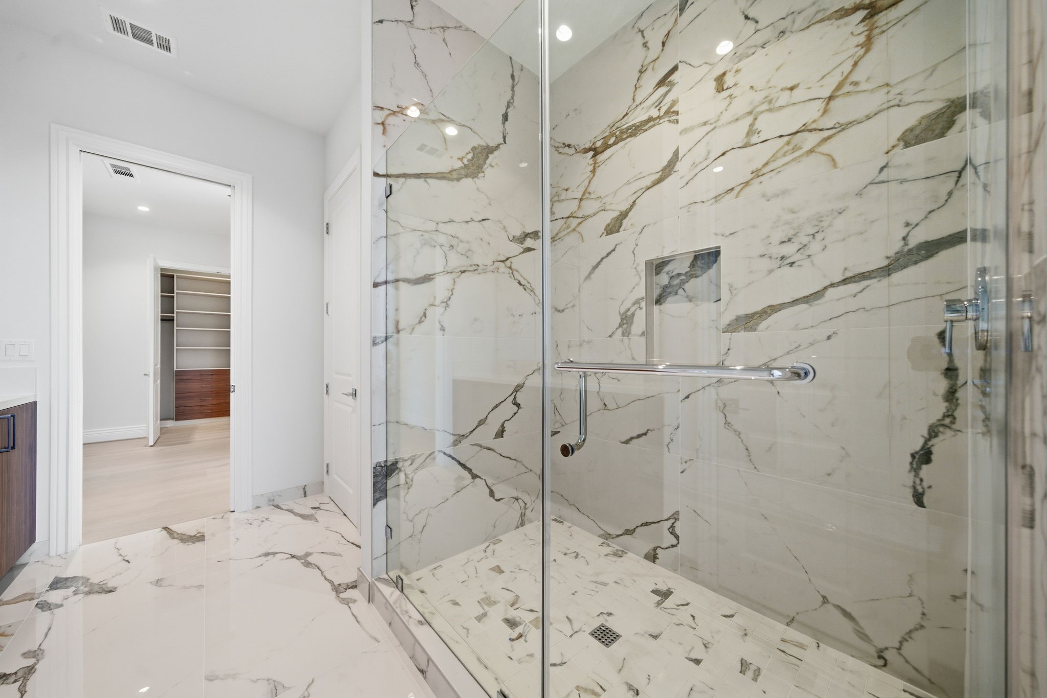 2323 San Felipe Street, Unit 803 Houston, TX 77019 - Photo 27 of 45 Hollywood Bath: A true standout, the shower is clad in dramatic marble, seamless glass shower and double sinks.