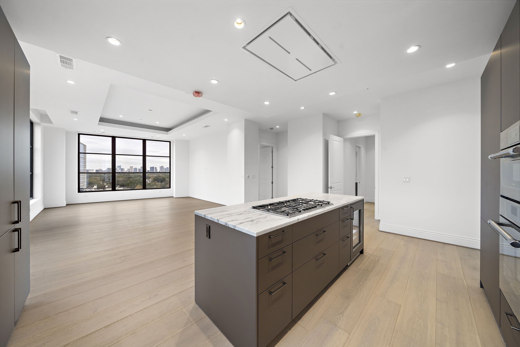 2323 San Felipe Street, Unit 803 Houston, TX 77019 - Photo 7 of 45 Kitchen features ample storage, gas cooktop & and extra beverage cooler.