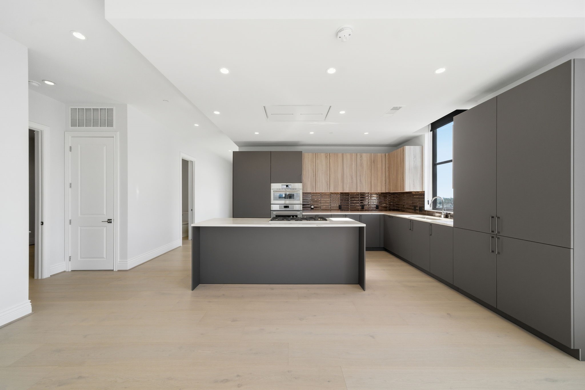 2323 San Felipe Street, Unit 803 Houston, TX 77019 - Photo 10 of 45 The large island serves as a central gathering place for family and friends, complementing the overall open-concept layout.