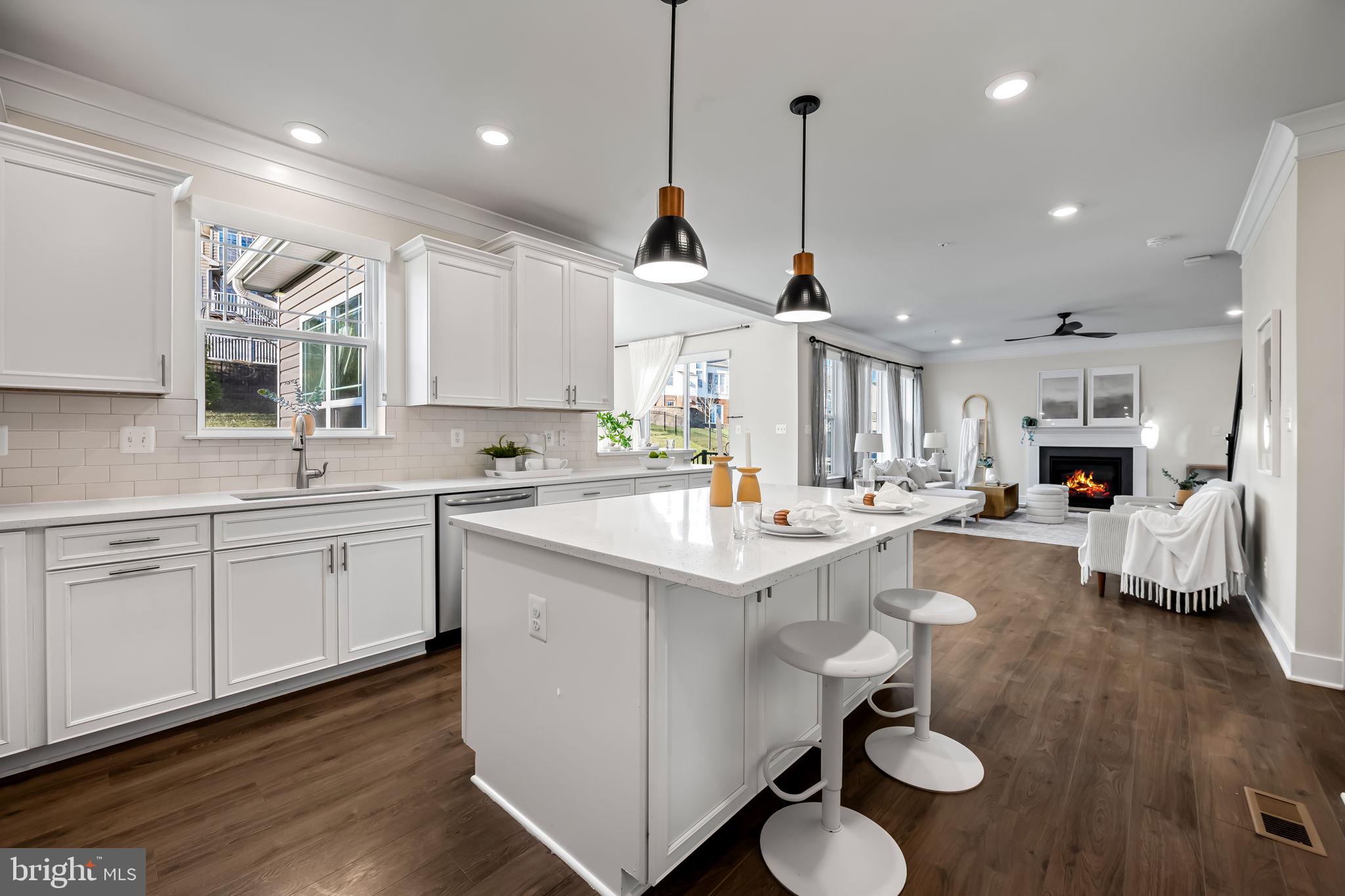 3704 Kahl Farm Road Perry Hall, MD 21128 - Photo 13 of 52 a kitchen with sink stove and white cabinets with wooden floor