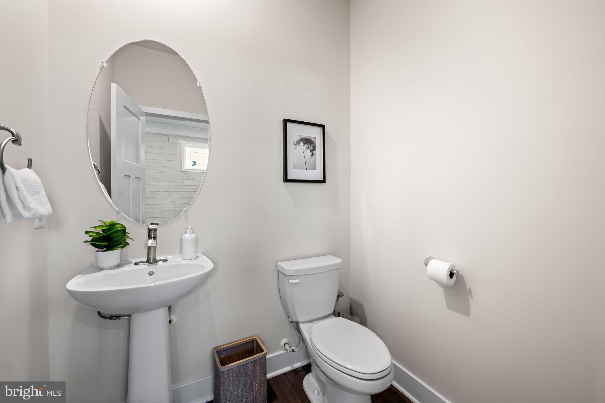 3704 Kahl Farm Road Perry Hall, MD 21128 - Photo 17 of 52 a bathroom with a toilet a sink and mirror