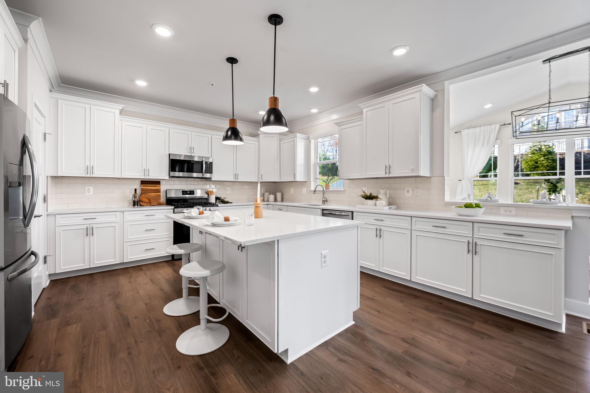 3704 Kahl Farm Road Perry Hall, MD 21128 - Photo 4 of 52 a kitchen with kitchen island granite countertop a sink cabinets and wooden floor