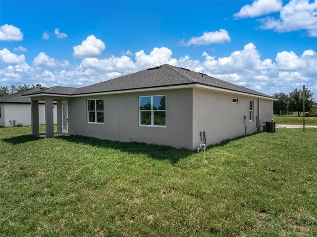 a view of a house with a backyard