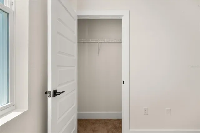 a bathroom with a sink a toilet a mirror and shower