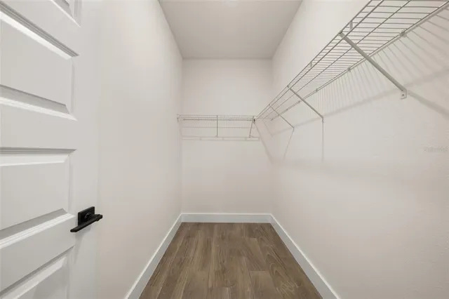 a view of walk in closet with empty racks