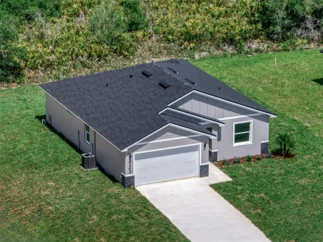 front view of a brick house with a small yard