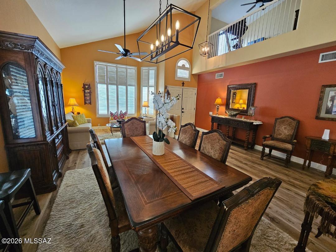 3130 West Star Ranch Trail Tucson, AZ 85742 - Photo 10 of 44 a view of a dining room with furniture window and wooden floor