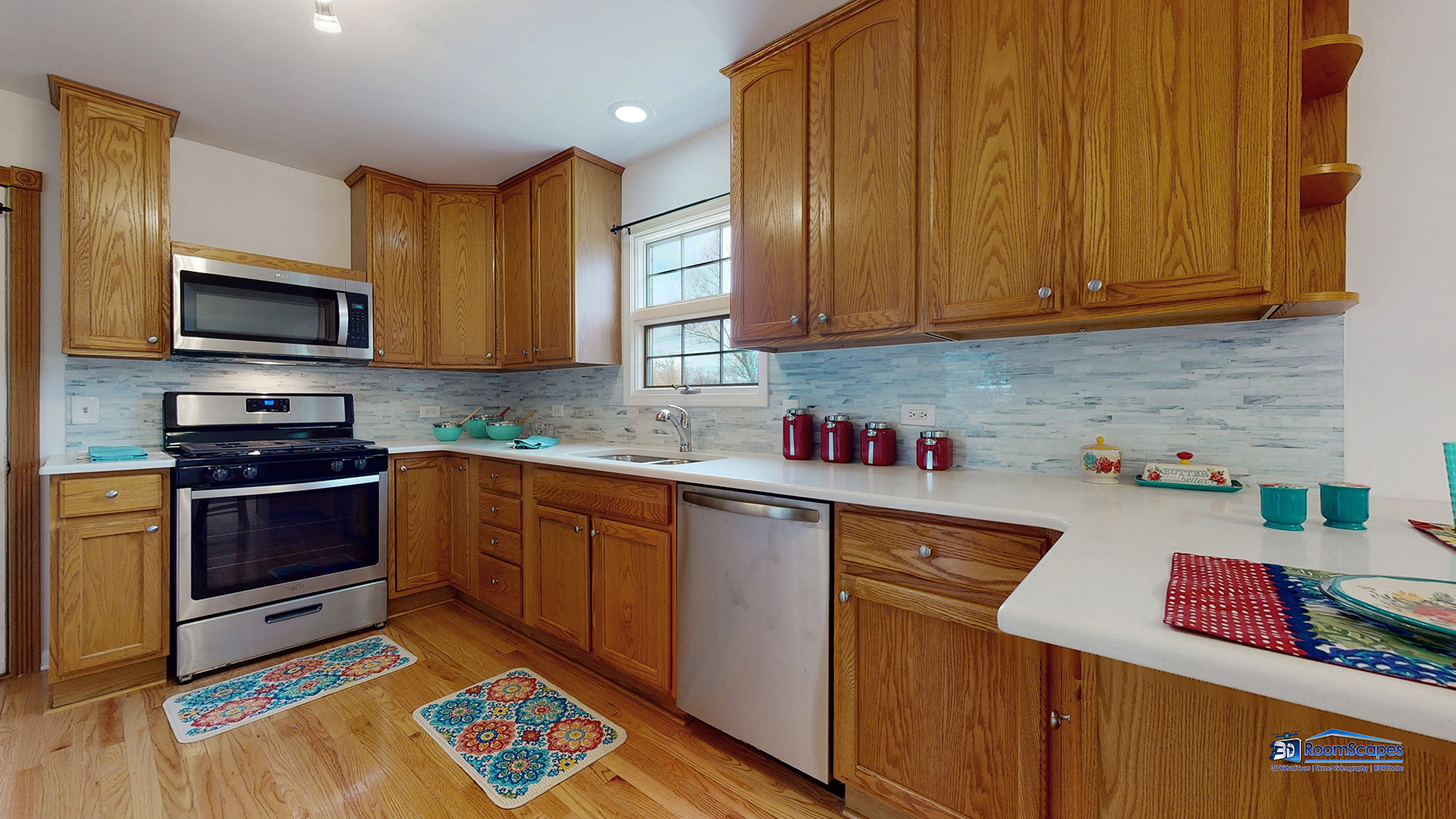 277 Mayflower Court Gurnee, IL 60031 - Photo 11 of 42 a kitchen with stainless steel appliances granite countertop a sink dishwasher stove and microwave with wooden cabinets