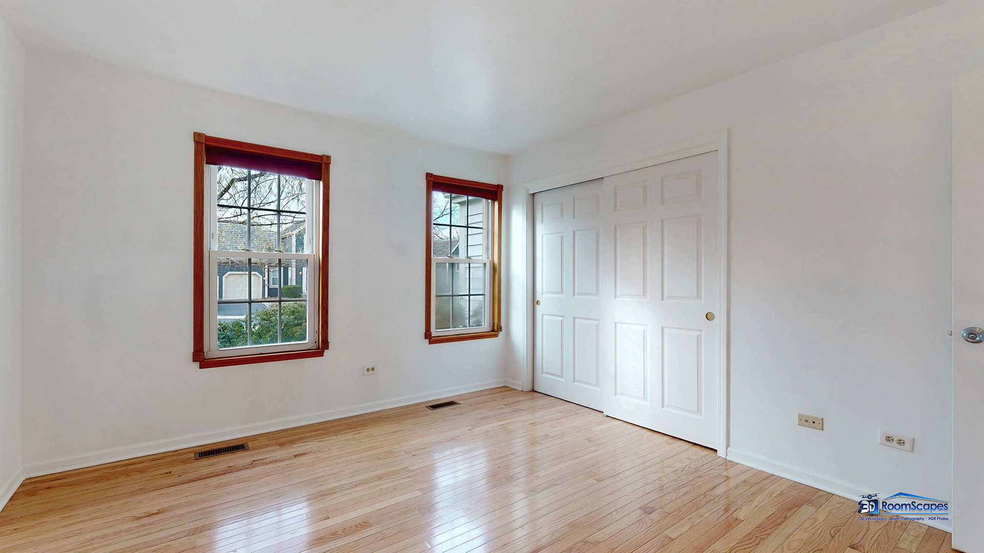 277 Mayflower Court Gurnee, IL 60031 - Photo 16 of 42 an empty room with wooden floor and windows