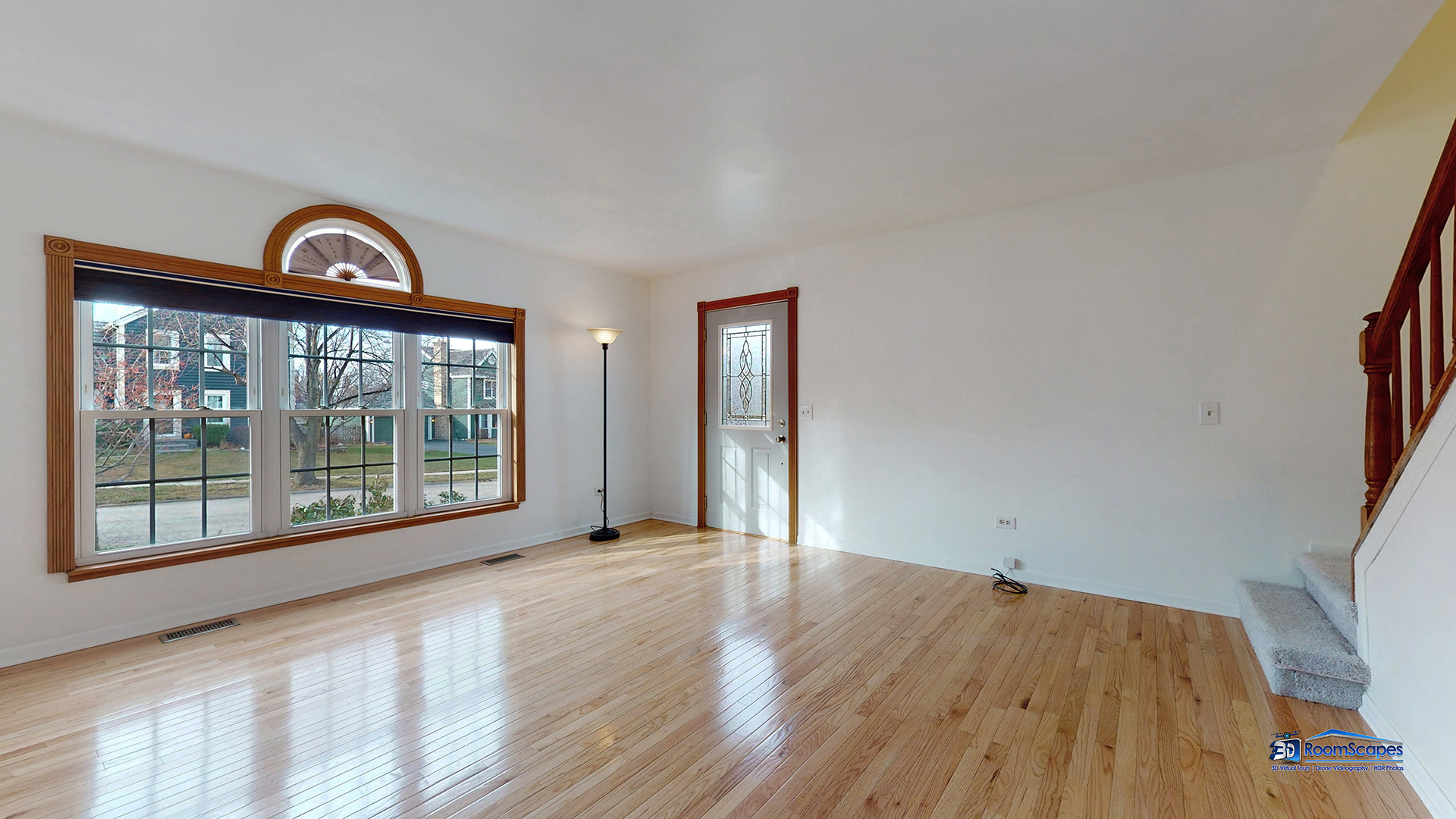 277 Mayflower Court Gurnee, IL 60031 - Photo 7 of 42 a view of a big room with wooden floor and a window