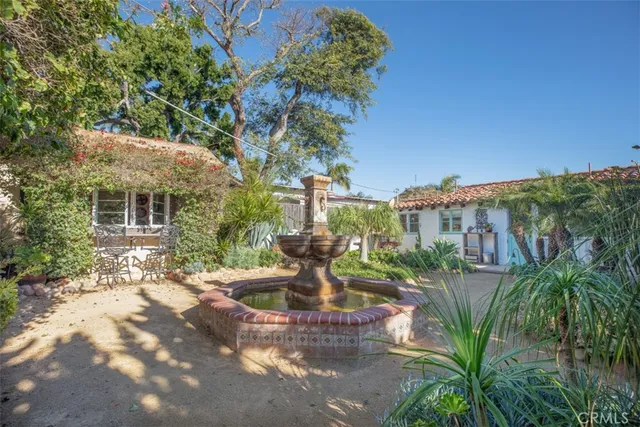 a view of a fountain in the backyard of a house