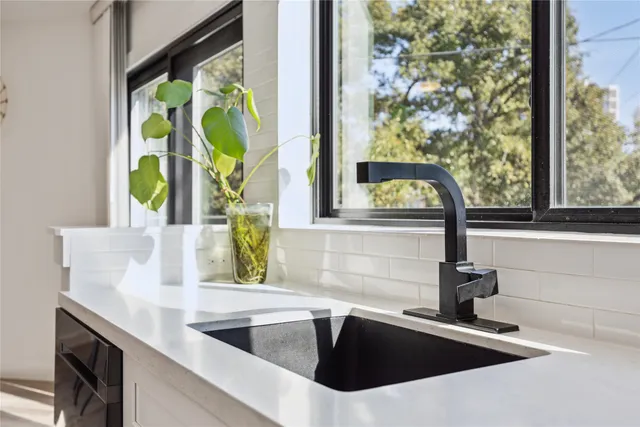 a kitchen with a sink and a large window