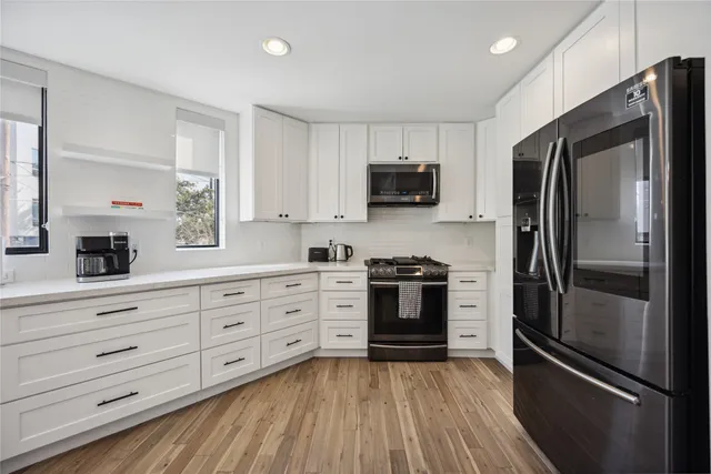 a kitchen with a refrigerator stove and microwave