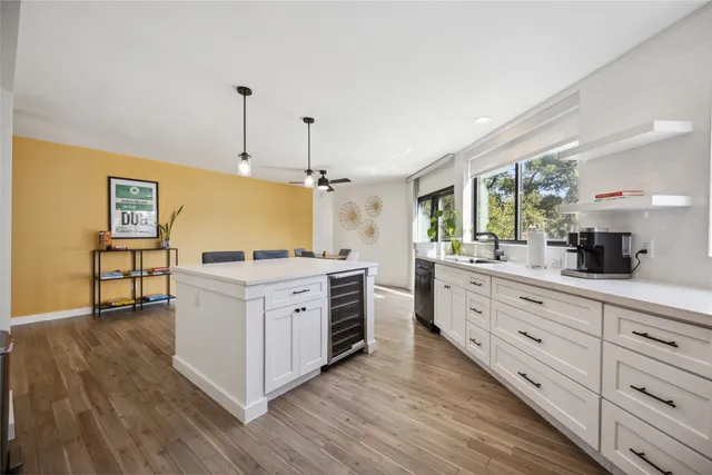 a kitchen with cabinets oven and a wooden floor