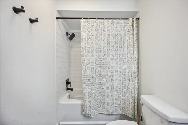 a bathroom with a shower curtain