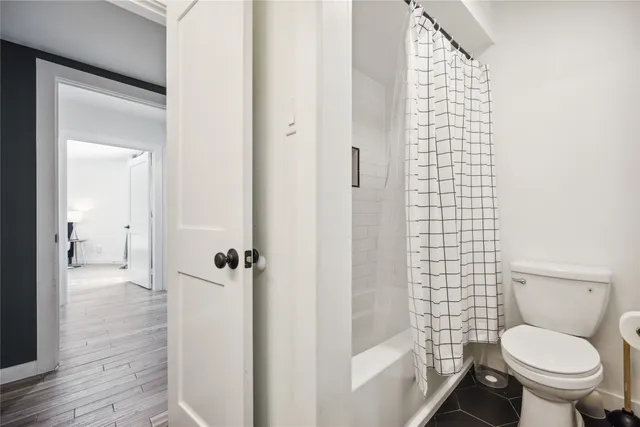a bathroom with a toilet and a shower