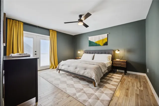 a bedroom with a bed and a chandelier