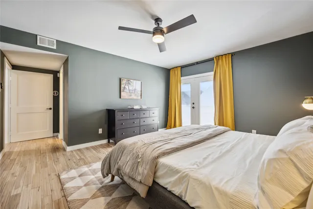 a bedroom with a bed and a chandelier