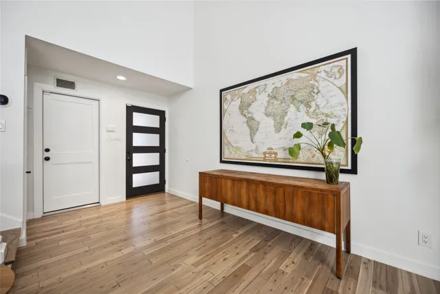 a view of a room with wooden floor and window