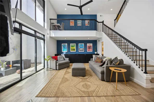 a living room with furniture and a floor to ceiling window