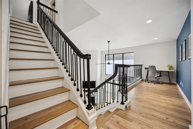 a view of entryway and hall with wooden floor