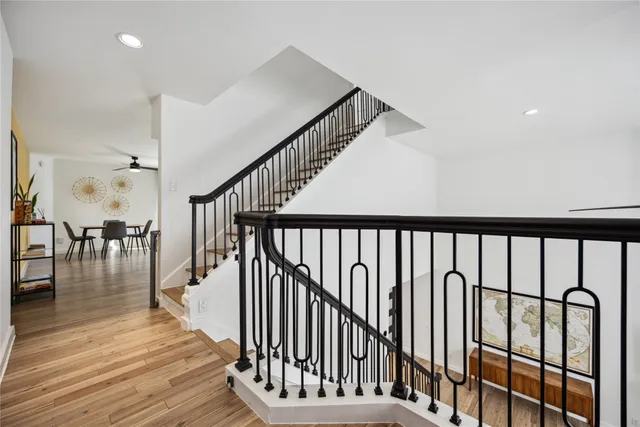 a view of staircase with wooden floor and a rug