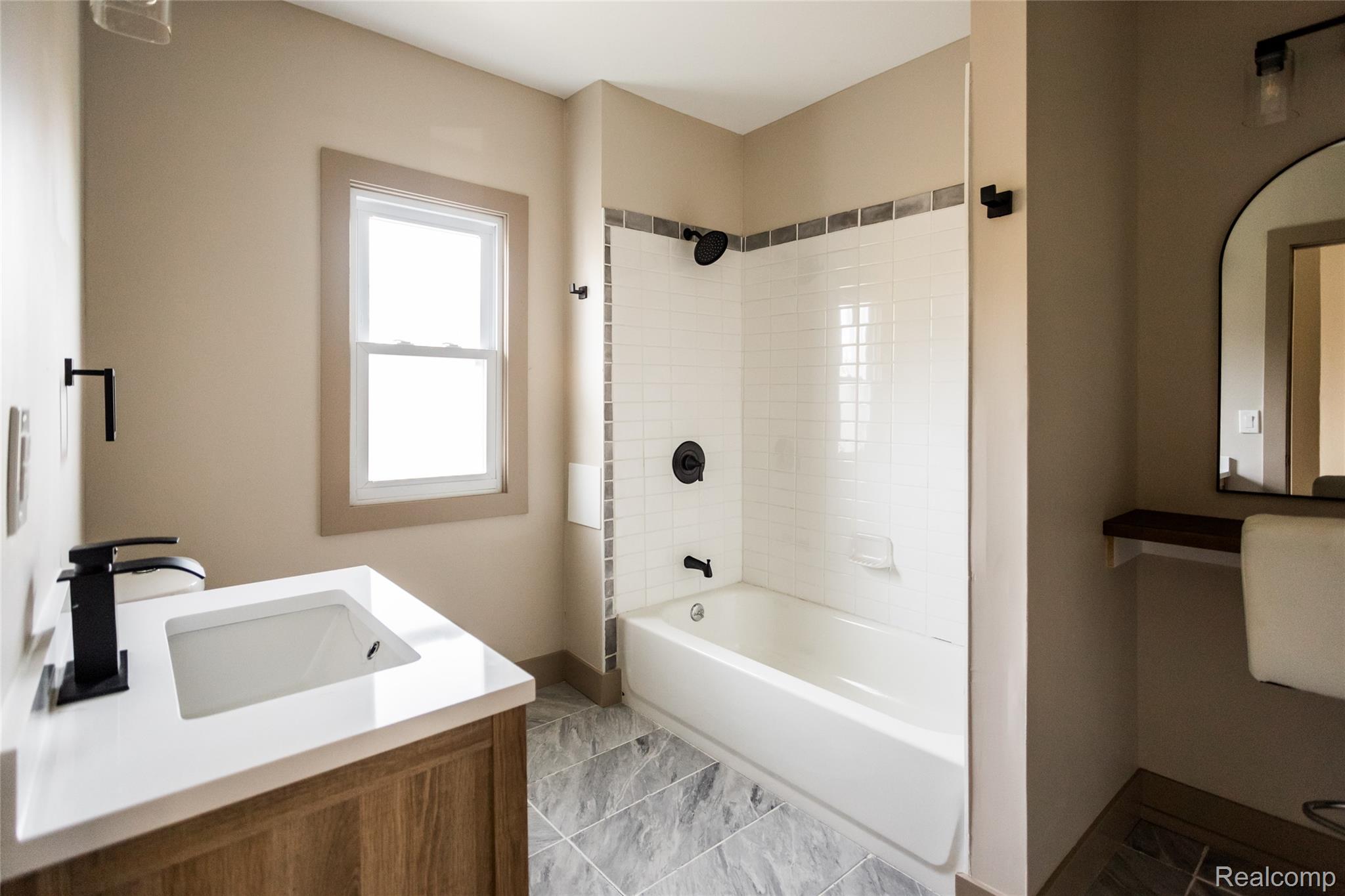 2630 Harding Street Detroit, MI 48214 - Photo 28 of 30 Contemporary bathroom featuring a wood-finish vanity with a white countertop and integrated sink