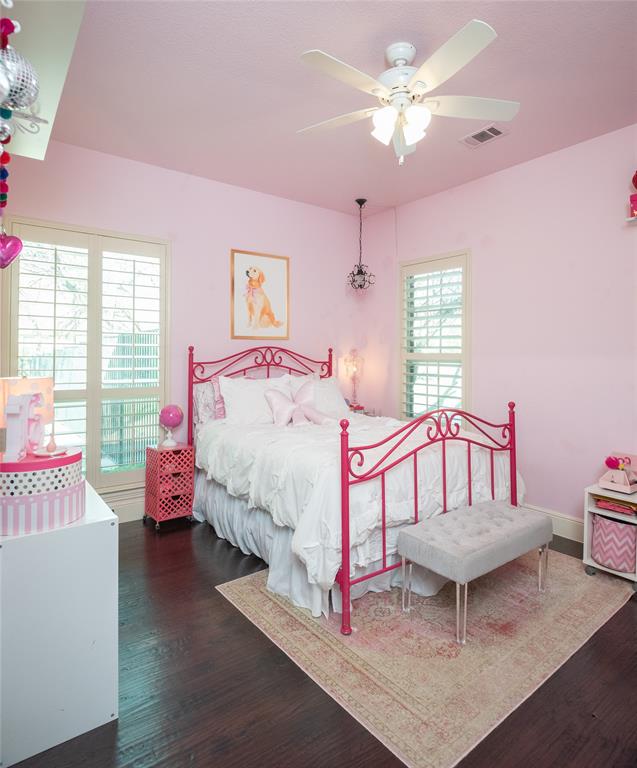 811 Red Store Court Lucas, TX 75002 - Photo 18 of 31 a bedroom with a bed a chandelier and dresser