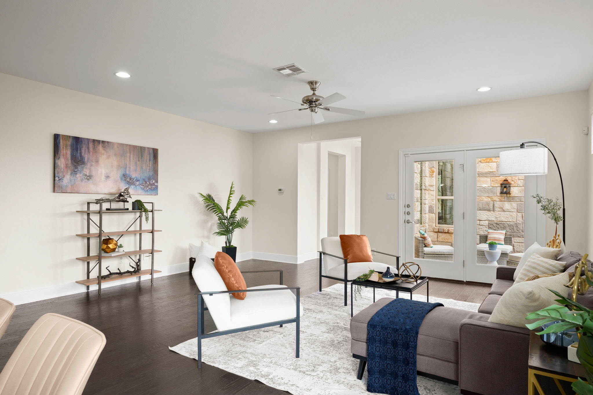 440 Cherokee Rose Circle Georgetown, TX 78626 - Photo 18 of 39 Recessed lighting illuminates this bright living room with dark wood flooring and access to a private outdoor space.